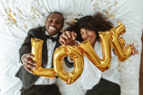 Free A Couple Holding Love Balloons Stock Photo