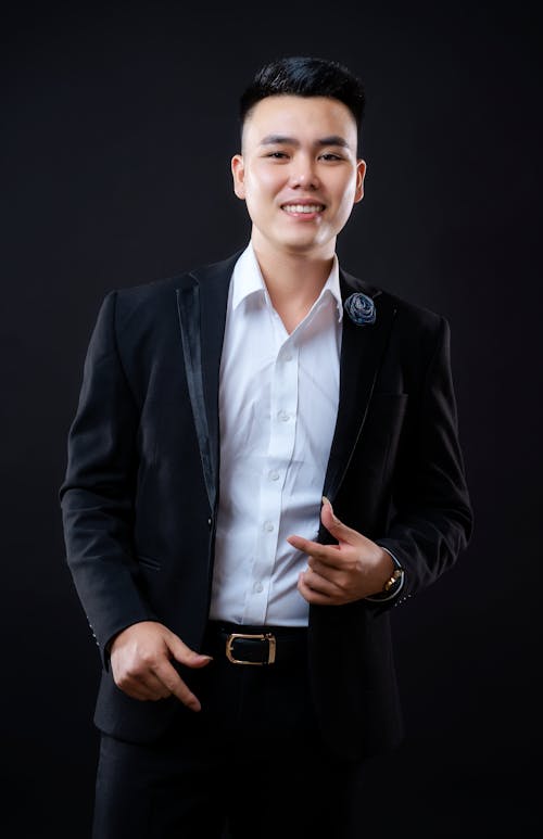 Photograph of a Man in a Black Suit Smiling for the Camera