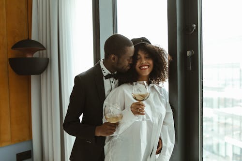 Photo of a Couple Holding Wine Glasses