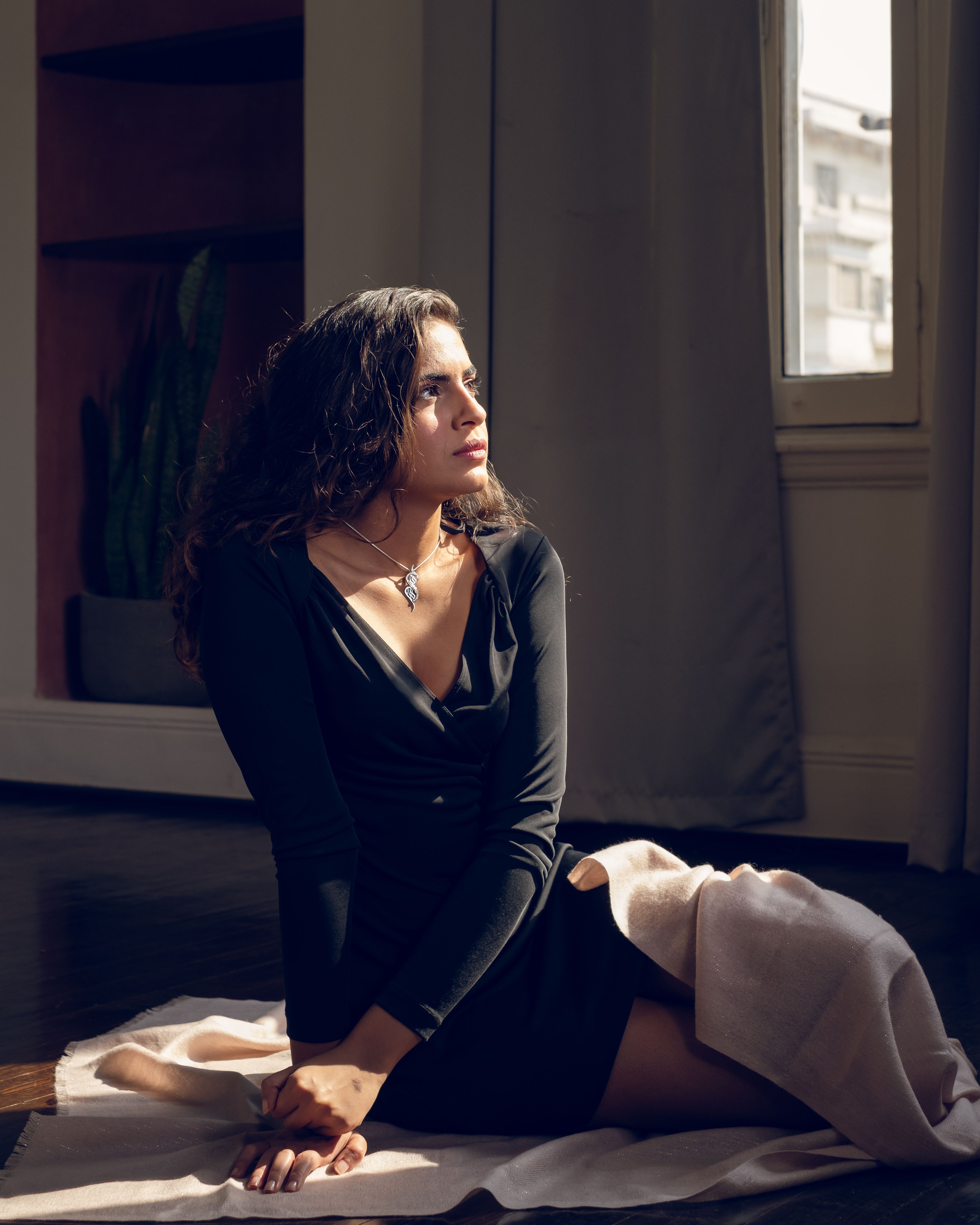 Woman in Black Dress Sitting on the Floor · Free Stock Photo