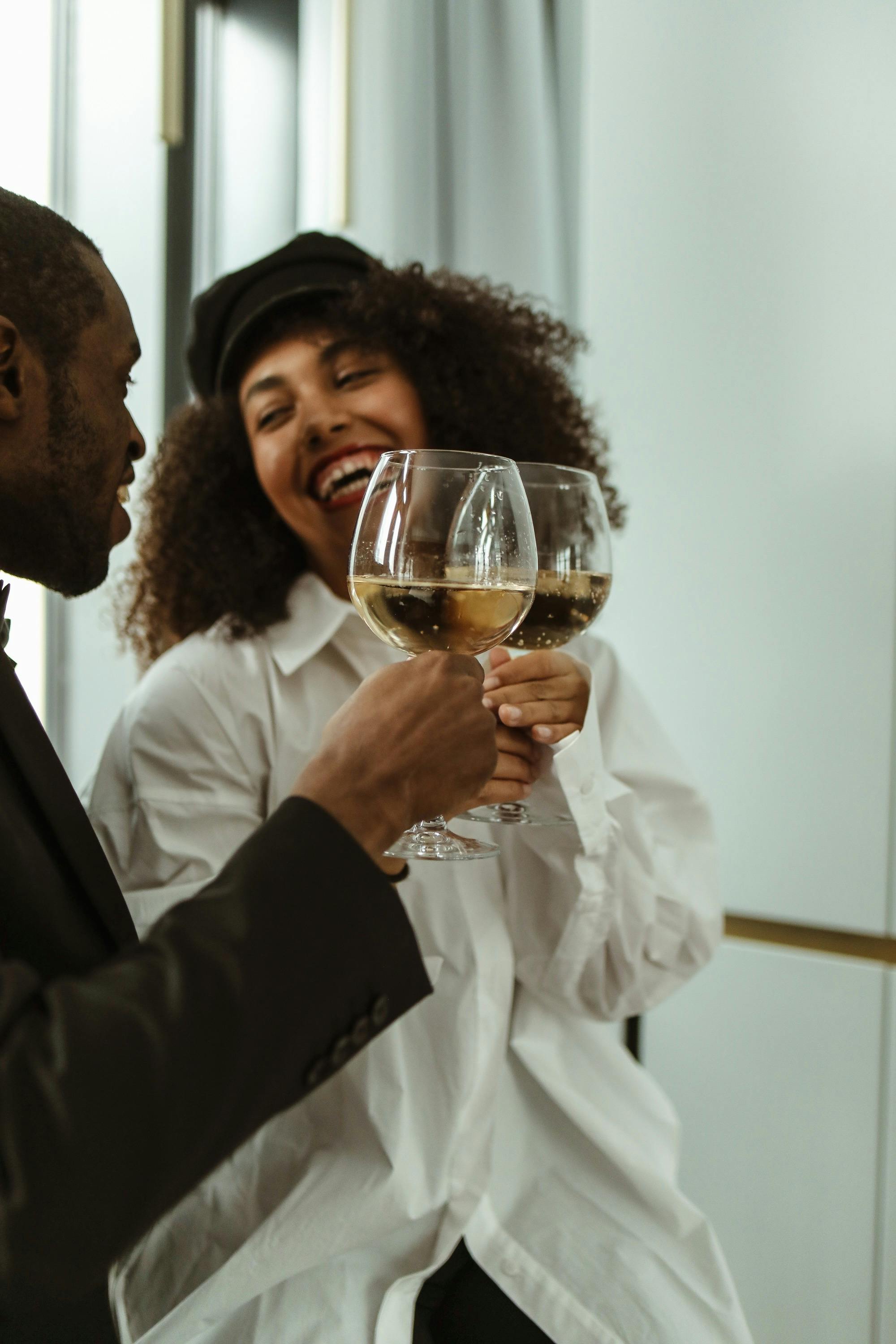 man and woman holding alcoholic drinks