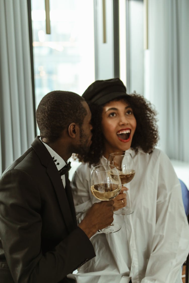 Person Whispering To A Woman