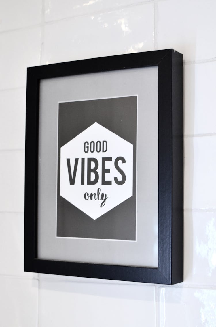 Framed Picture With Inspirational Text Hanging On Wall