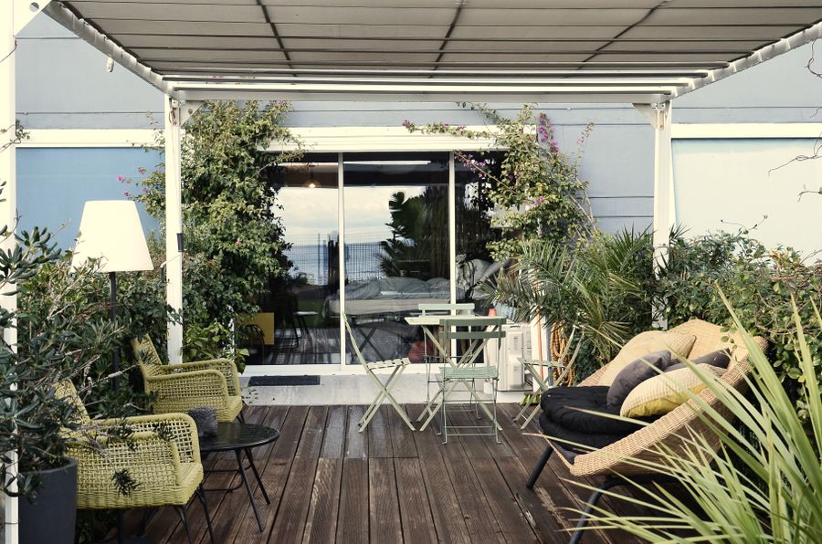 A finished patio with outdoor furniture surrounded by plants