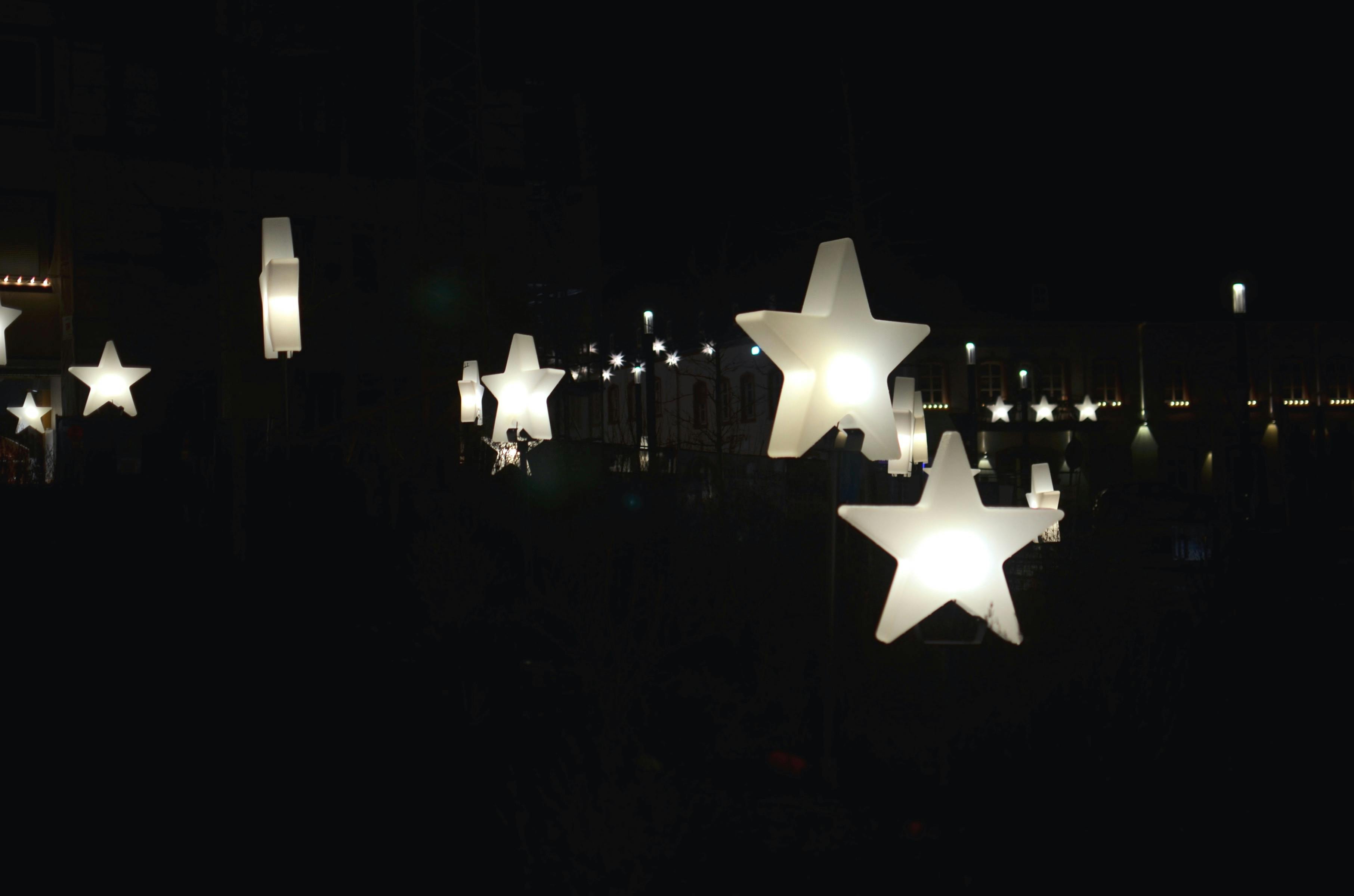 decorative star shaped garlands hanging on street at night