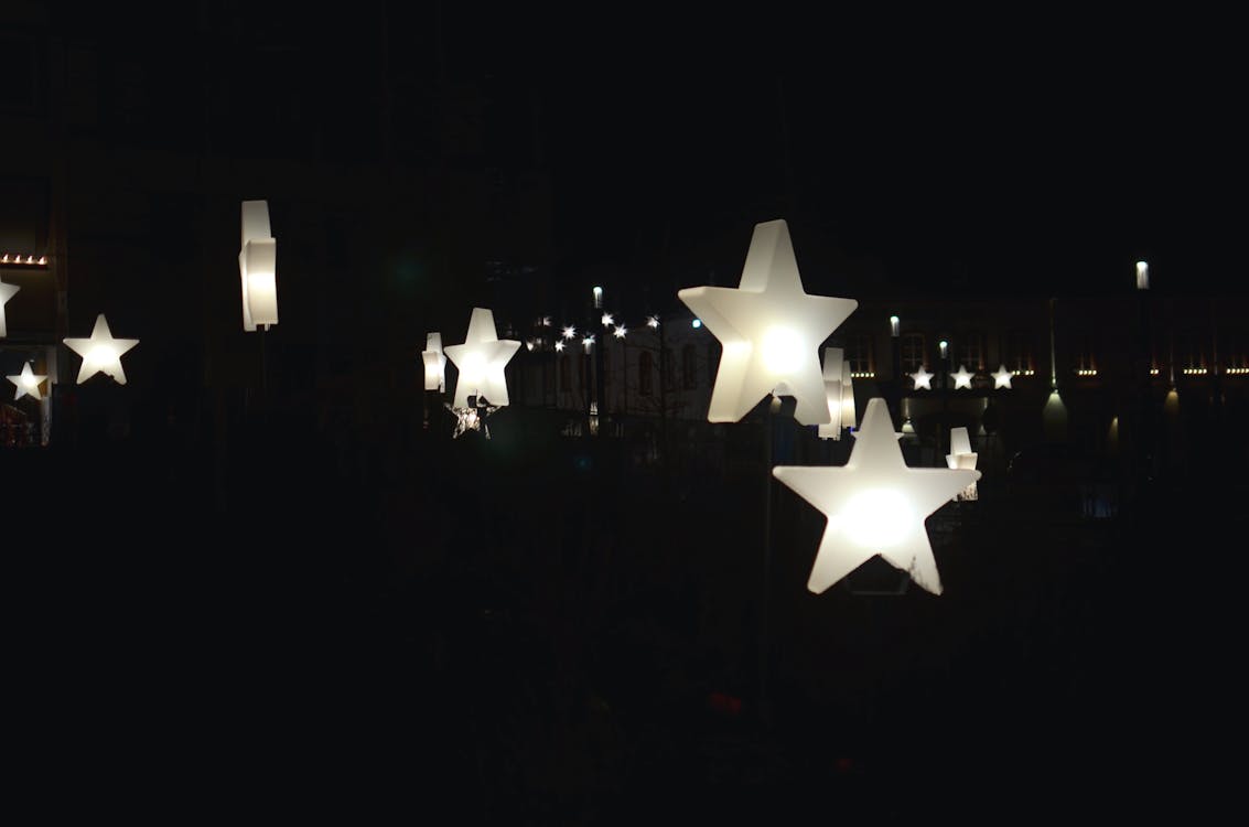 Decorative star shaped garlands hanging on street at night