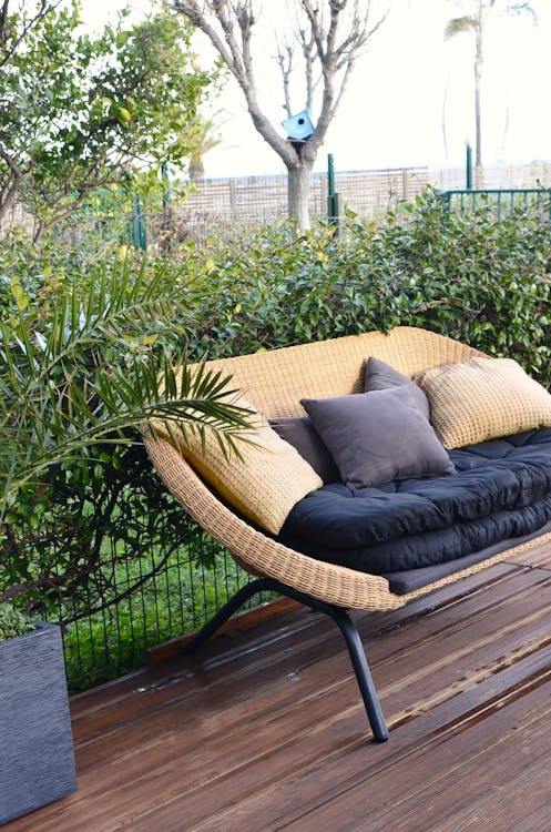Stylish wicker sofa placed in patio