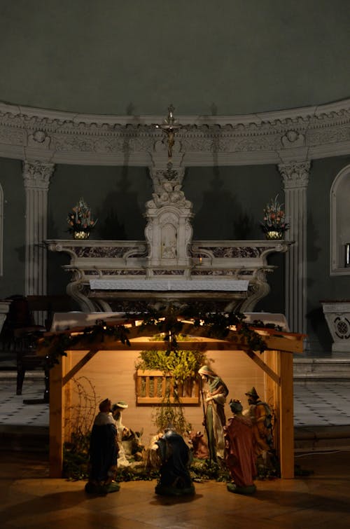 Biblical scene sculptures near altar of aged cathedral with bas reliefs and golden ornamental details