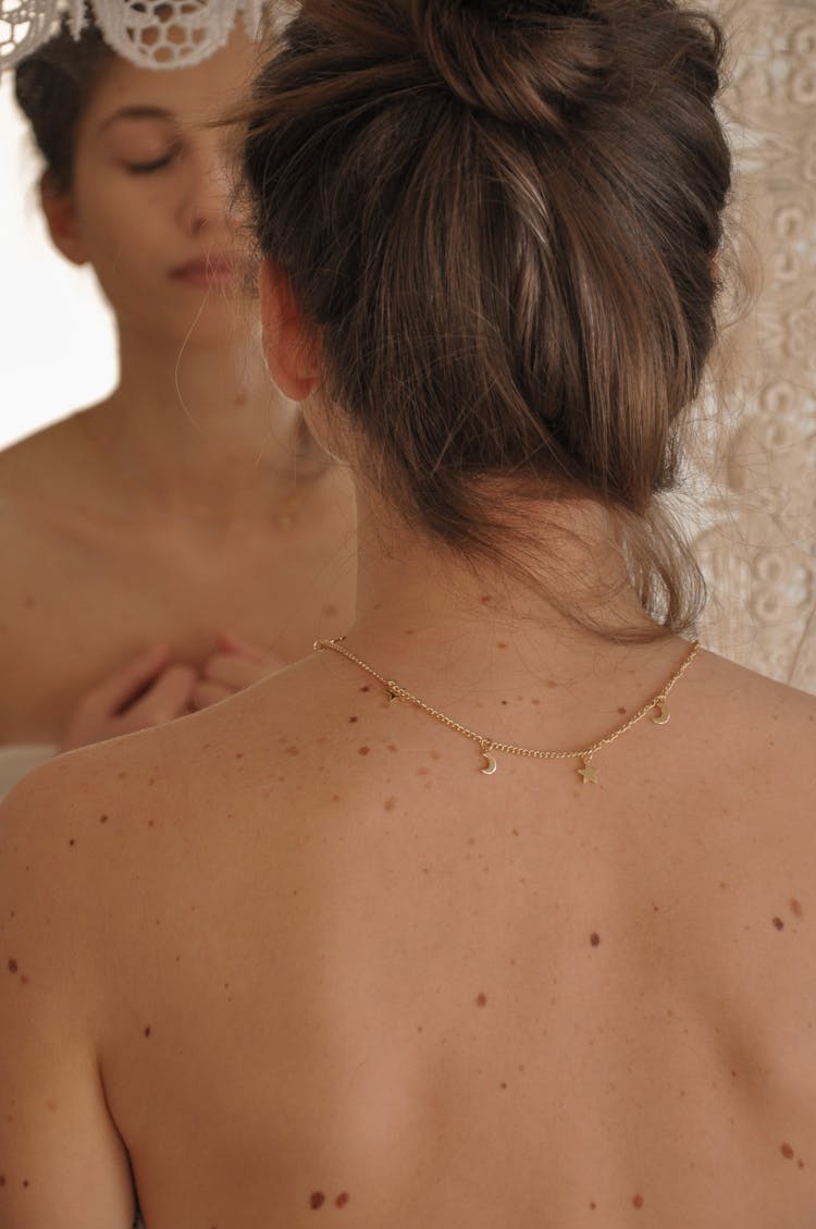 Woman With Bare Skin And Thin Necklace On Neck