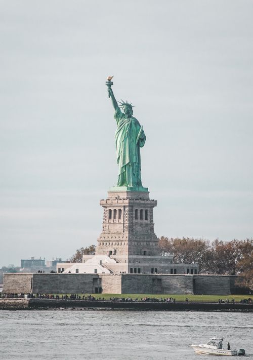 Free Iconic view of Statue of Liberty with Manhattan skyline in New York City, USA. Stock Photo
