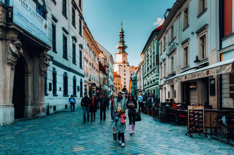Family walking through a European old town — photo by Helena Jankovičová Kováčová on Pexels