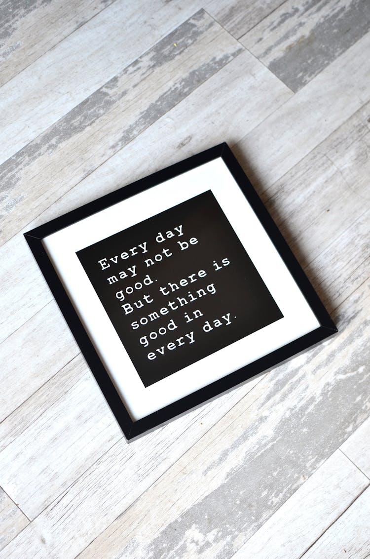 Inspirational Poster In Frame On Wooden Background