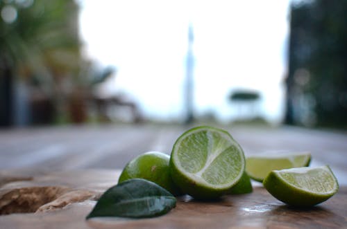 Sliced Lime on Brown Wooden Chopping Board