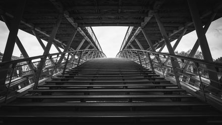 Pedestrian bridge at dusk by Pierre Blache on Pexels