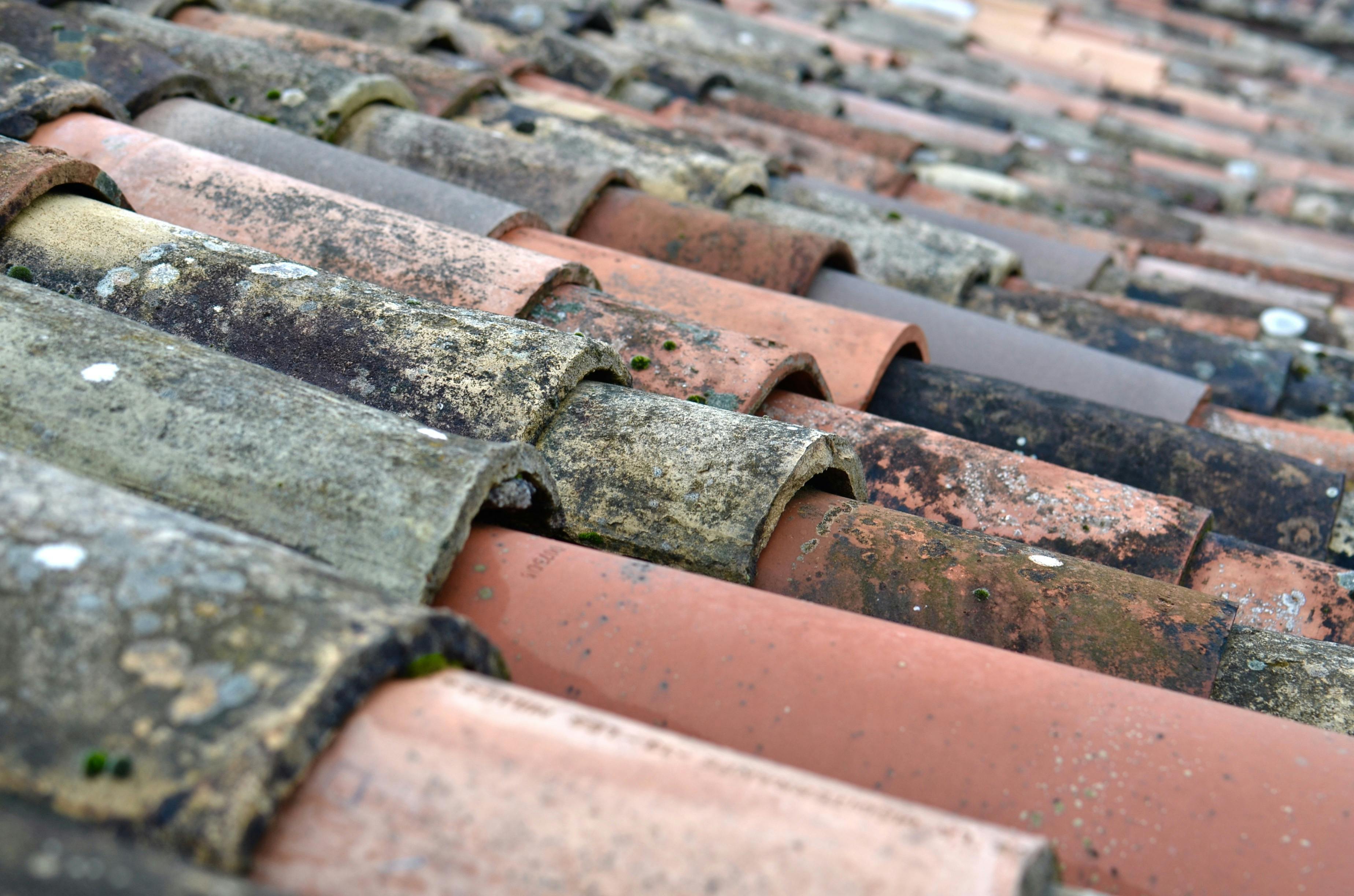 Detailed close-up of weathered terracotta roof shingles in Provence, France.