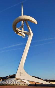 A striking view of the iconic Montjuïc Communications Tower against a clear blue sky in Barcelona.