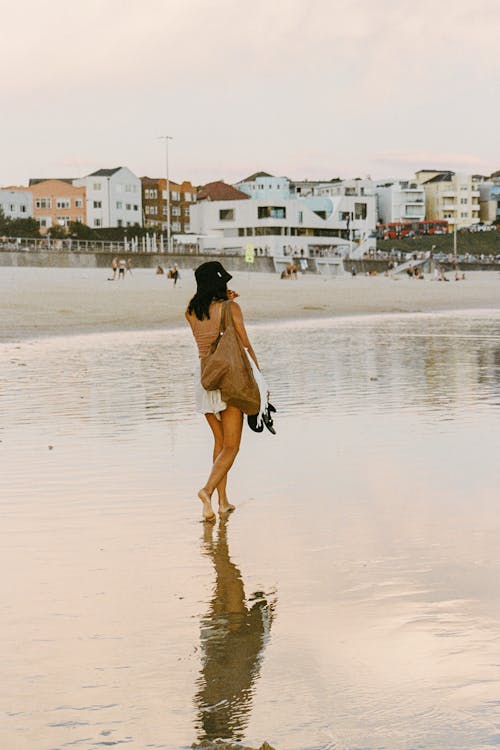 Woman walking Bare Footed on Seashore