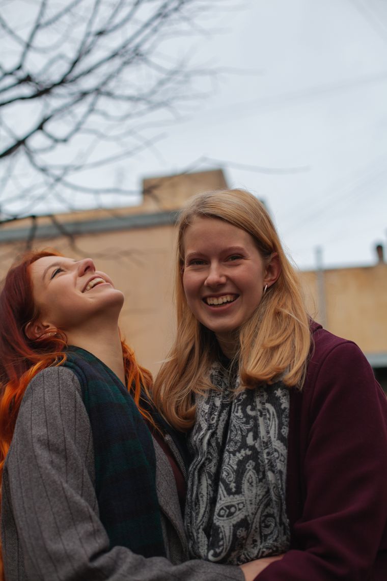 Two friends laughing outdoors, photo by Alexandr on Pexels