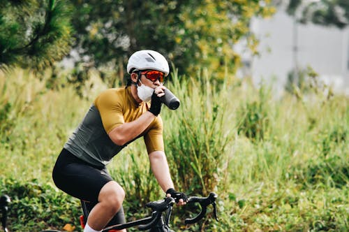 Kostnadsfri bild av ansiktsmask, cykling, cyklist