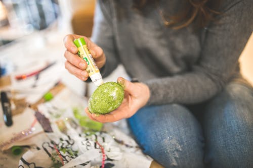 Woman decorating egg for Easter