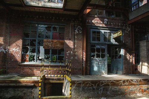 Free Explore this abandoned industrial site in Leipzig, Germany, featuring broken windows and brick walls covered in graffiti. Stock Photo
