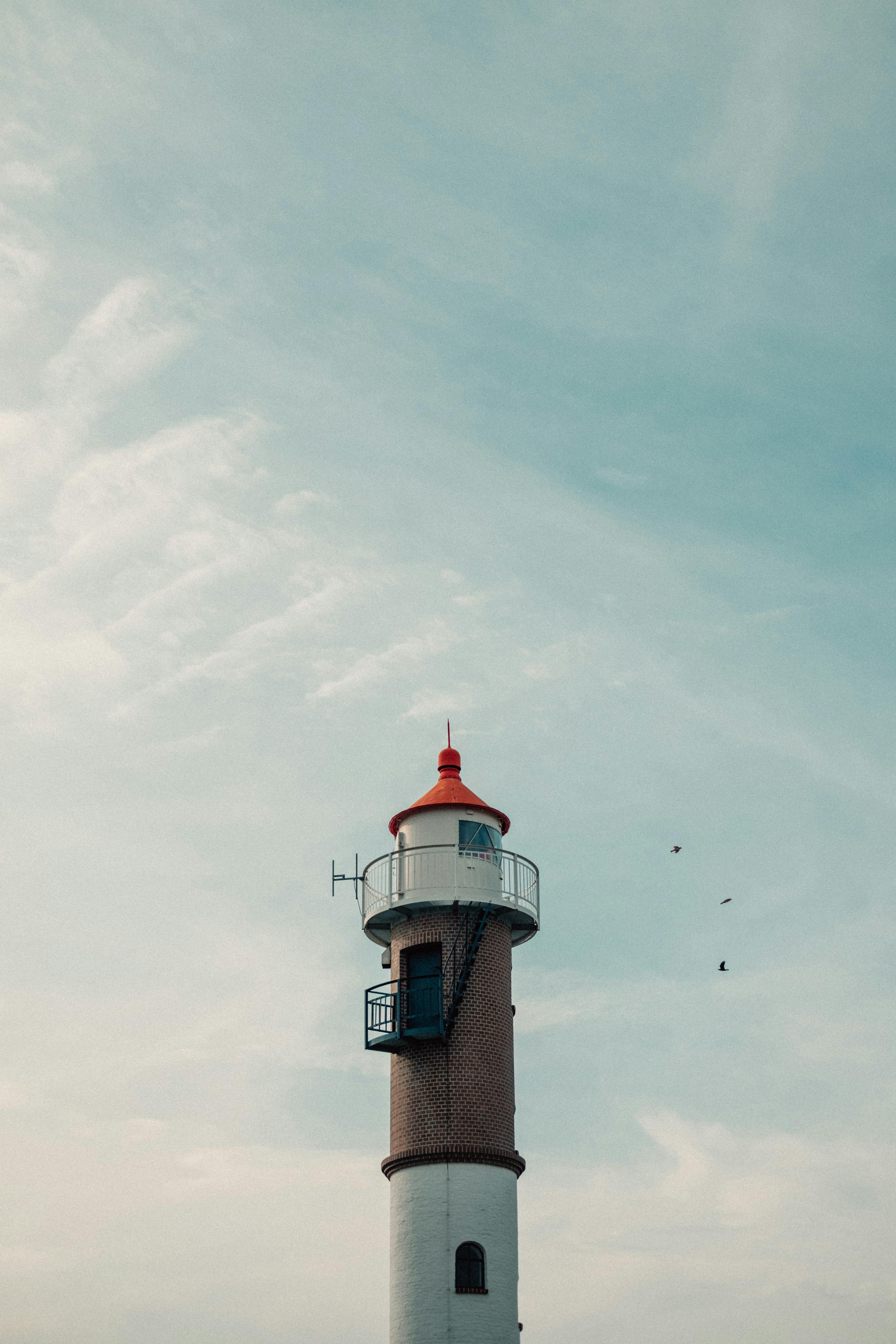 Scenic view of a historic lighthouse against a blue sky on Poel Island, Germany.