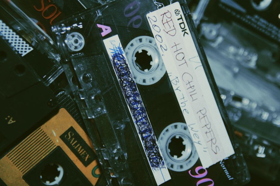 Close-up of retro cassette tapes, featuring handwritten labels and nostalgic aesthetics.
