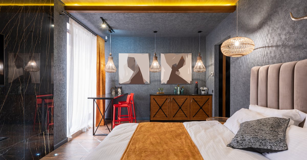 Interior of modern bedroom with comfortable bed and creative chandeliers