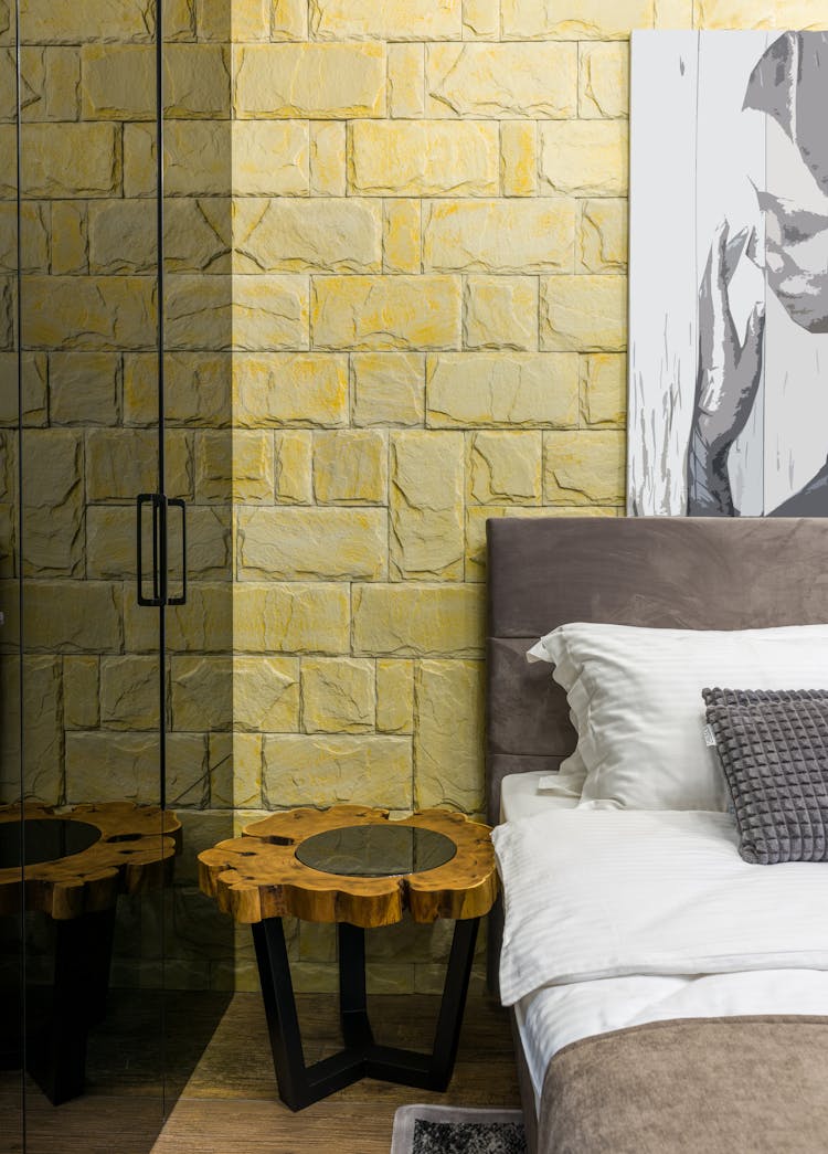 Bedroom Interior With Bed And Artwork On Brick Wall