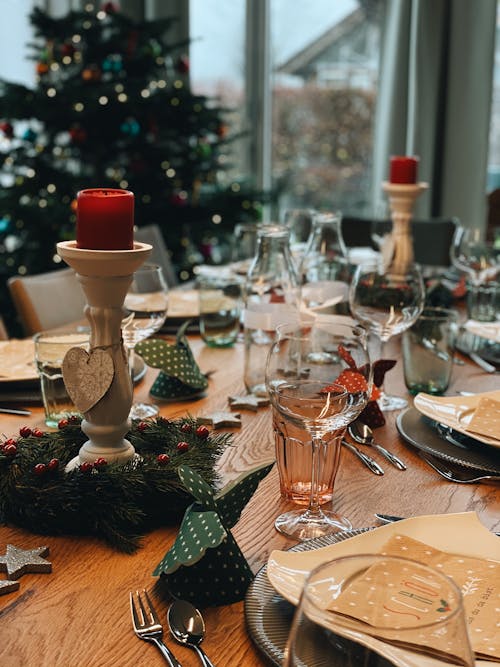 A Table Setting with Christmas Decorations on a Wooden Table