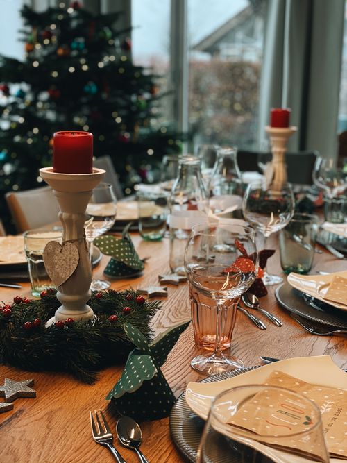 Free Warm and inviting Christmas table setting with candles, perfect for holiday gatherings. Stock Photo