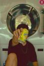 Person Holding Yellow and Blue Plastic Cup