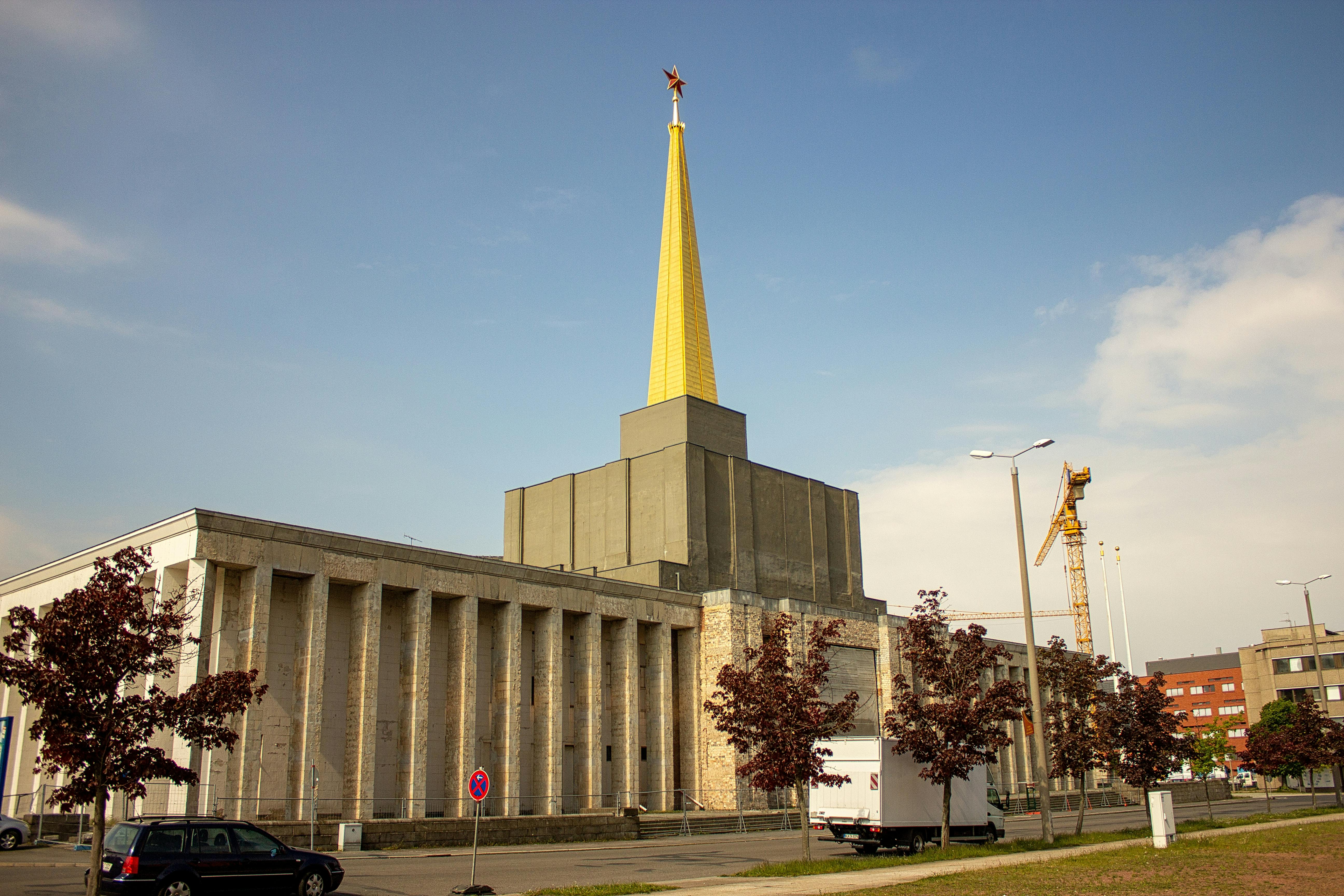 Iconic Old Trade Fair building in Leipzig, Germany, with a distinct gold spire.