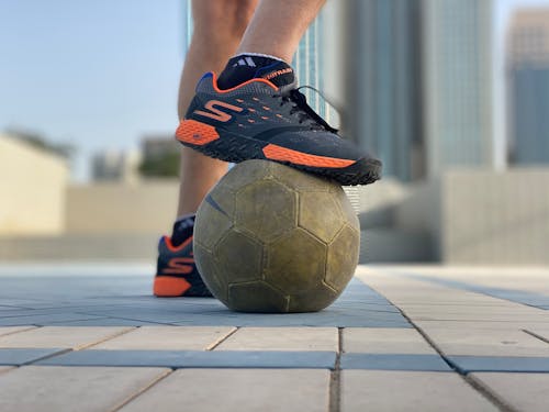 Person Stepping on a Ball