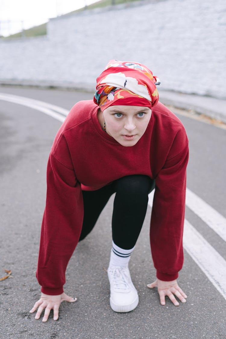 A Woman Wearing Headscarf In A Standing Sprint Start Position