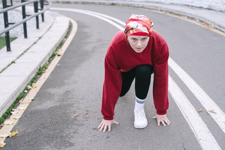 A Woman Wearing Headscarf In A Standing Sprint Start Position
