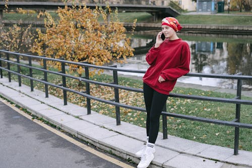 A Woman in Red Sweater Having a Phone Call
