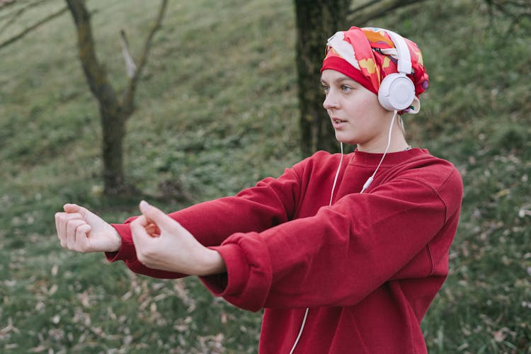 Woman Wearing White Headphones And Red Sweater