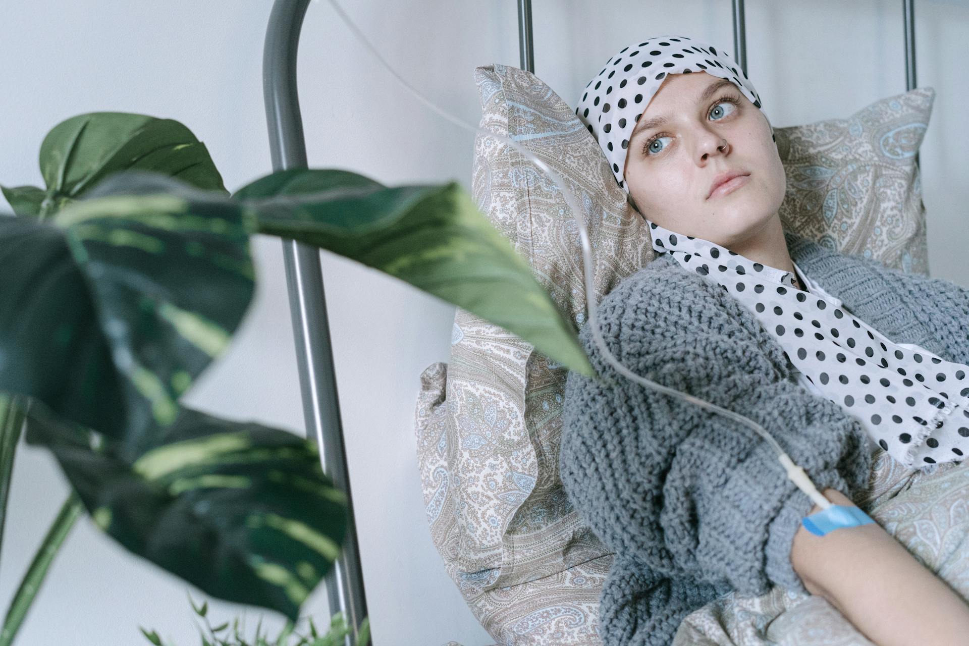 A Woman Wearing Headscarf Having a Treatment while Lying on Hospital Bed