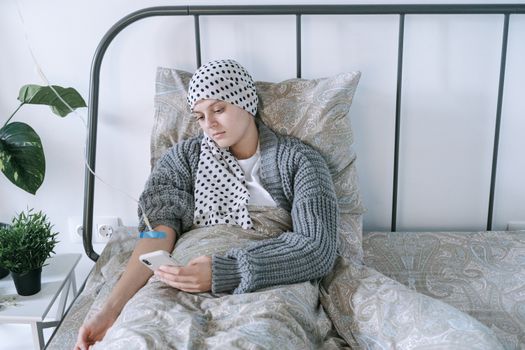Woman in Gray Sweater Sitting on Bed