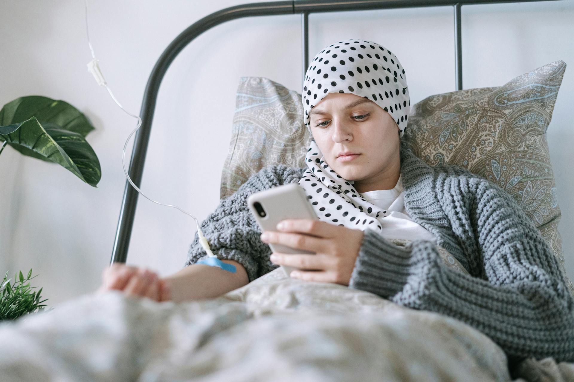 A Woman Using Her Phone while Undergoing Treatment