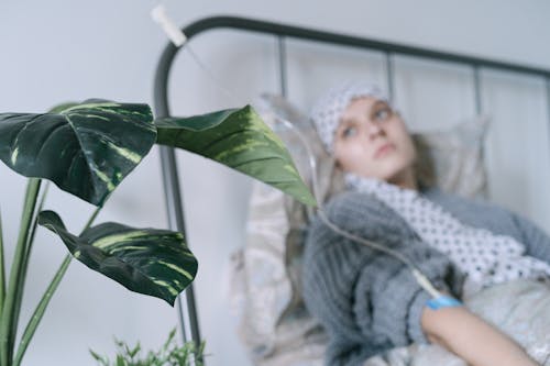 A Woman Lying in Bed while Undergoing Treatment