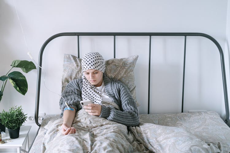 A Woman Lying In Bed While Undergoing Chemotherapy