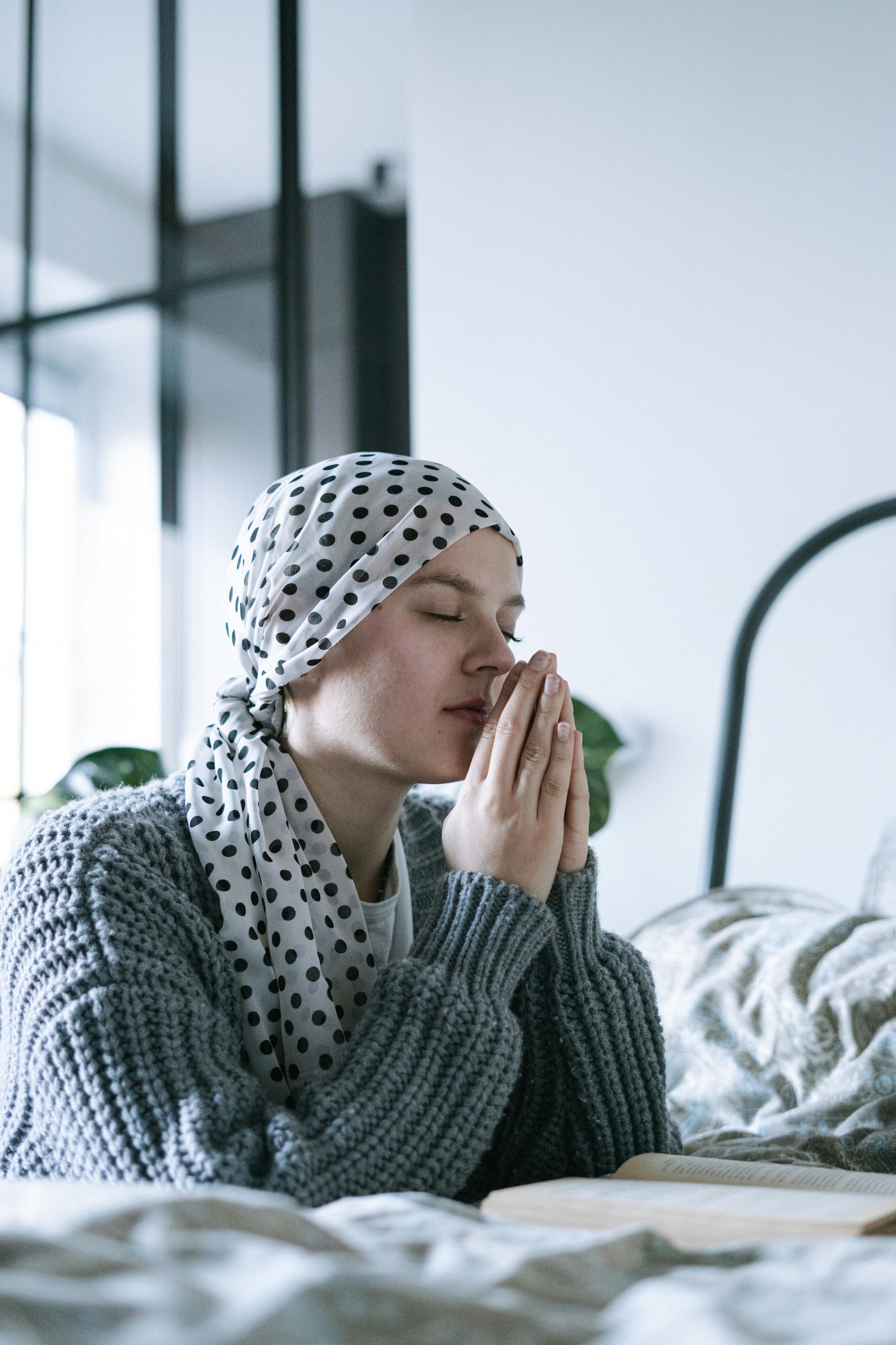 woman in white and black hijab covering her face