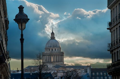 A Concrete Building Under White Clouds