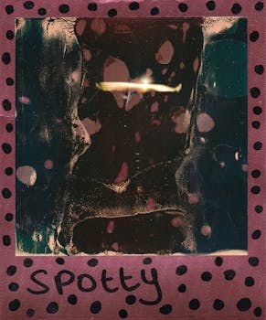 Abstract vintage Polaroid with artistic dark and light spots creating a unique design.