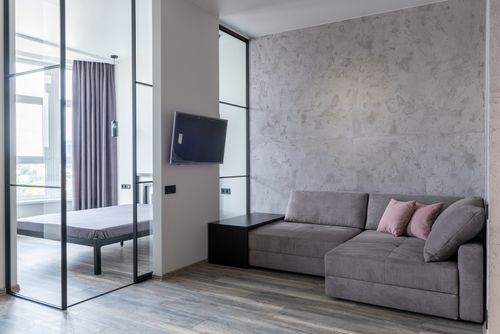 Free Contemporary living room interior with decorative cushions on couch against television and glass wall at home Stock Photo