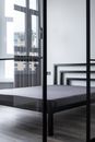 Contemporary bed with soft mattress against window and glass partition at home in daytime