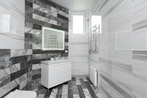 Modern bathroom interior with ceramic walls and mirror