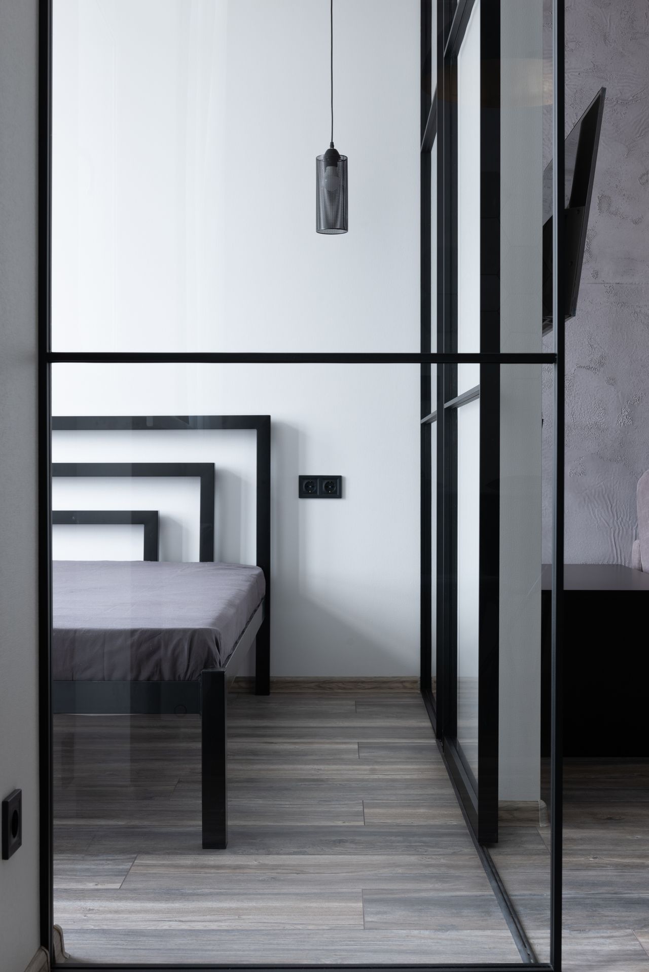 Black-framed glass partition wall dividing rooms in a home